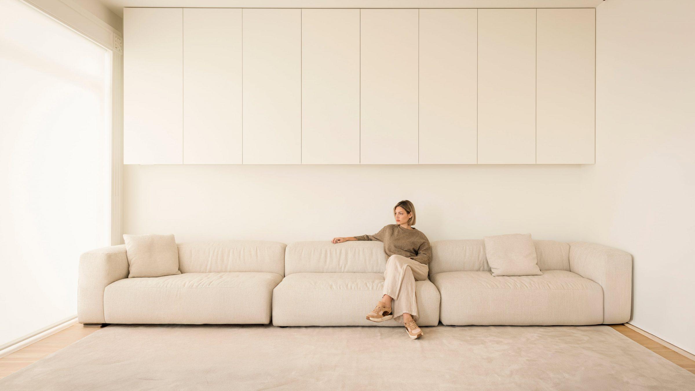 1928 Penthouse — main living room, long sofa under recessed cabinetry