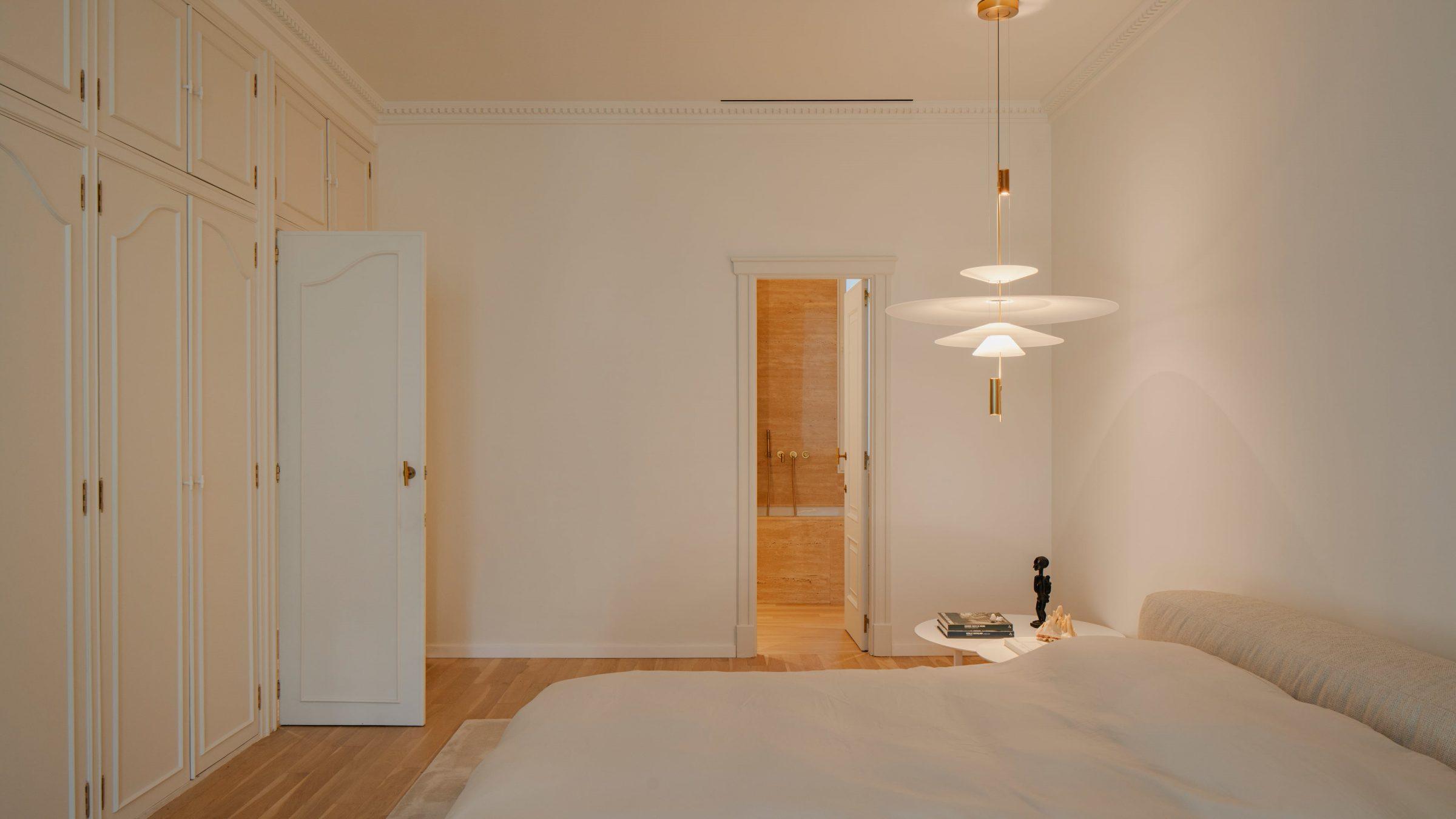 1928 Penthouse — master bedroom with original cornice and pendant lights