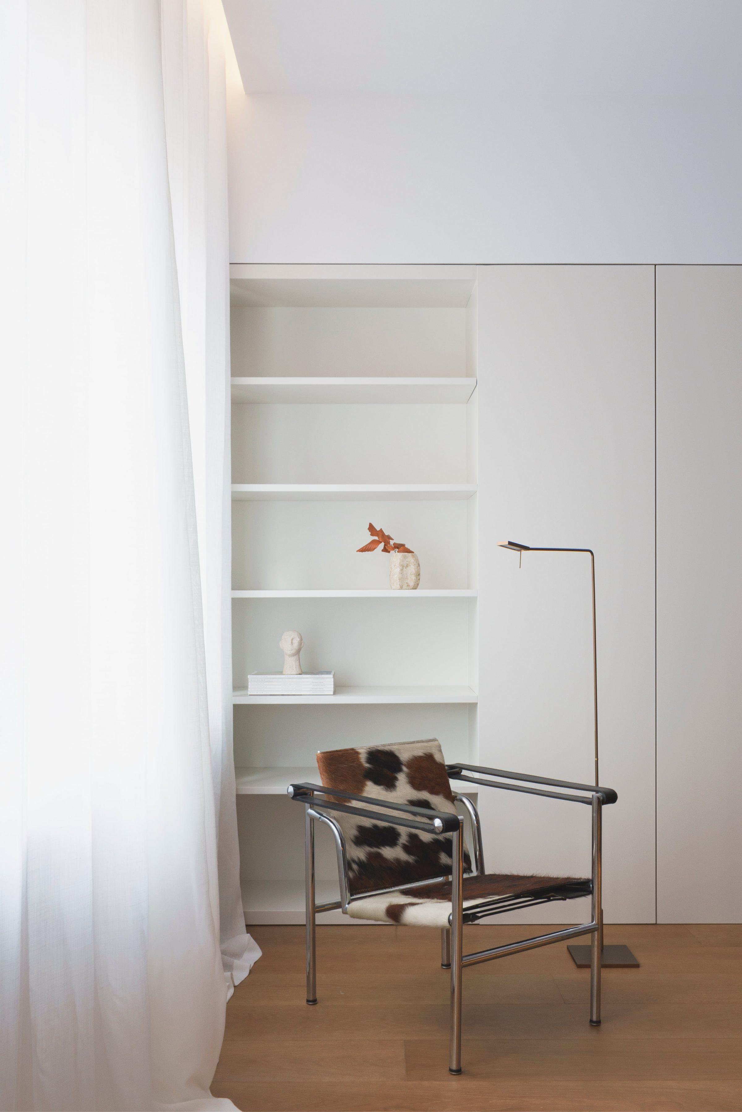 AO17 Apartment — white lacquered shelving with classic chair, continuous panelling logic