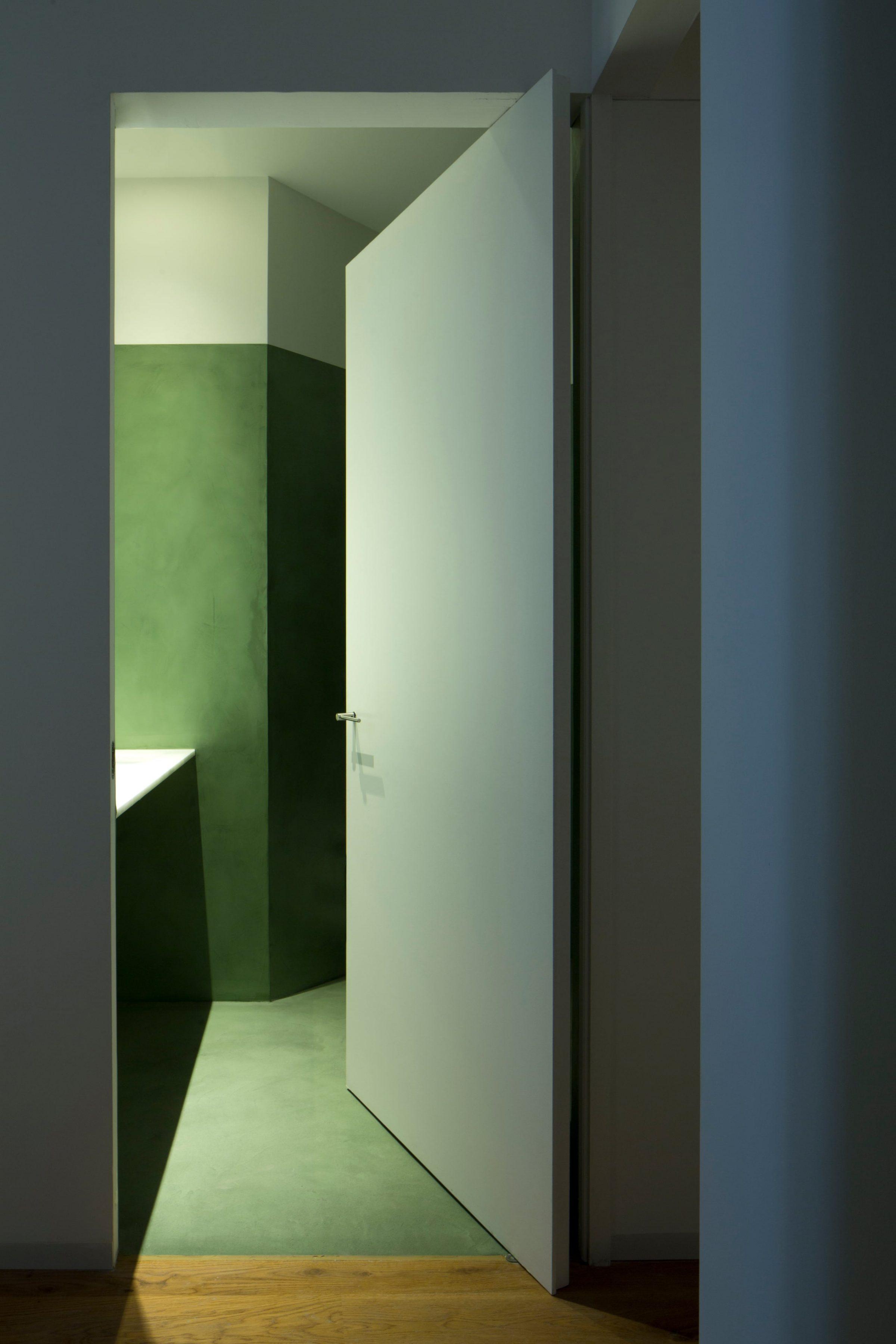 Ciscar Apartment — green-toned main bathroom, sole chromatic shift in the apartment