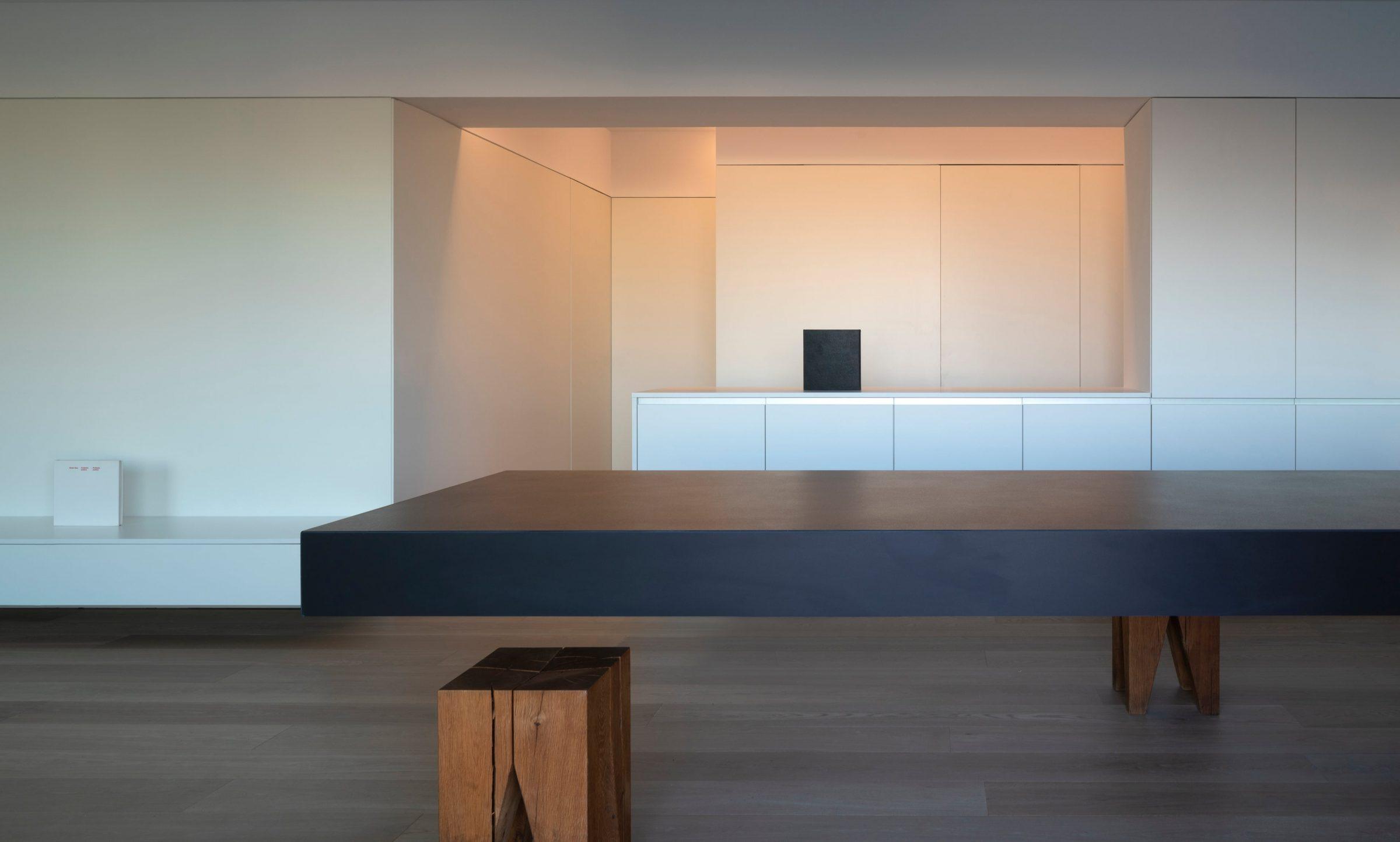 Orihuela Apartment, the living room with pale oak floor and dark counter