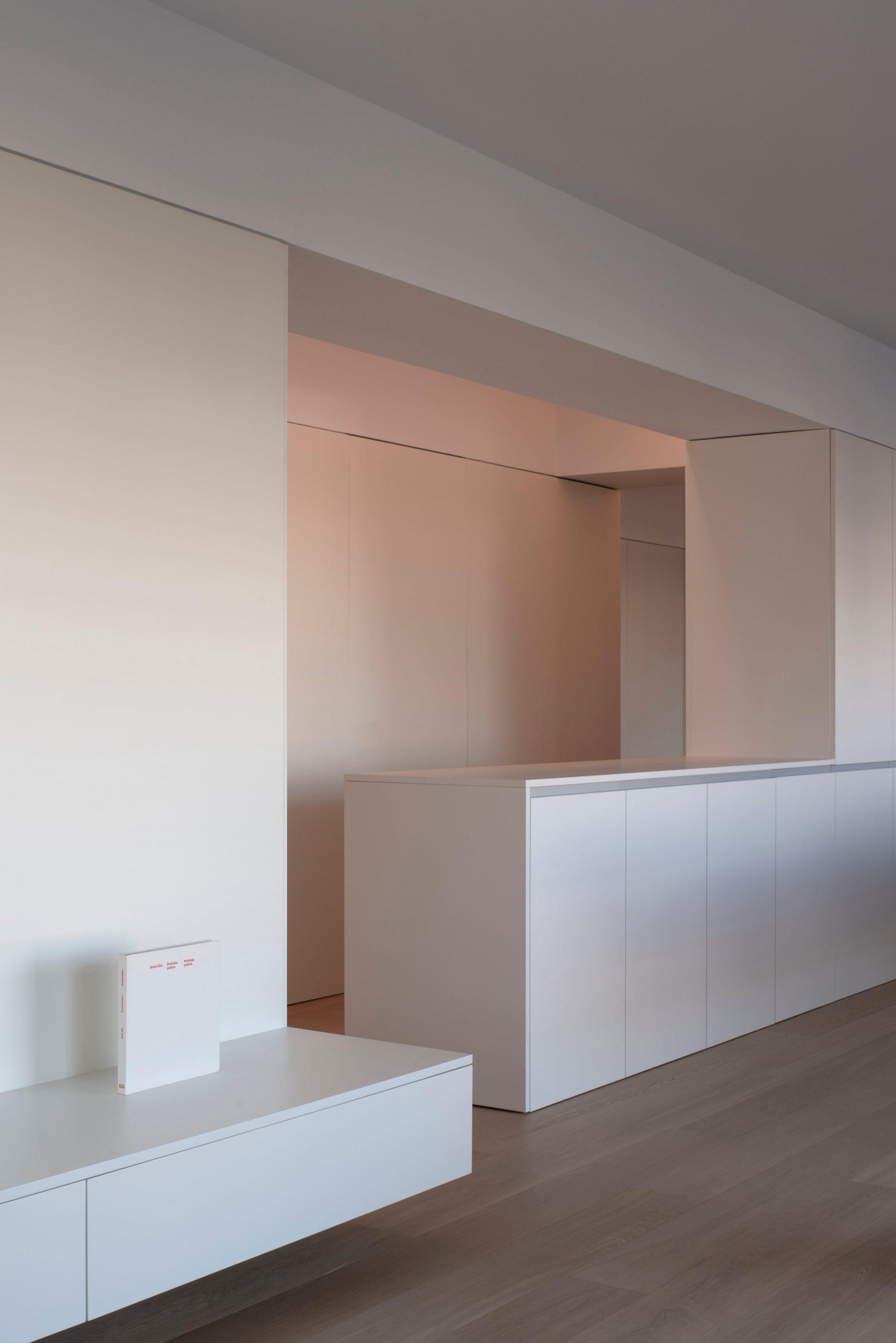 Orihuela Apartment, the kitchen counter framed by warm cove lighting from the ceiling