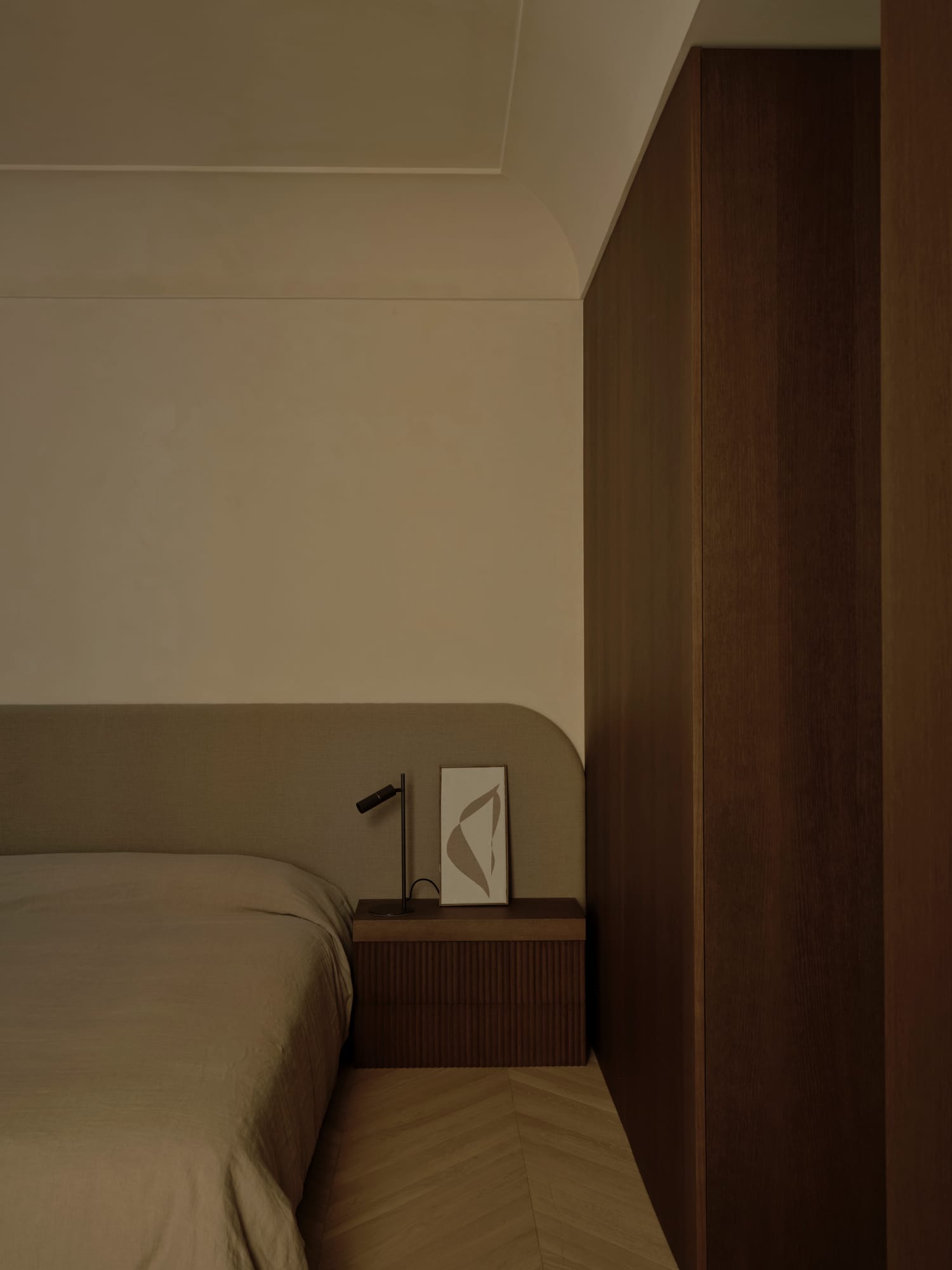 Ciutat Vella Apartment — bedroom with a framed work resting against the oak