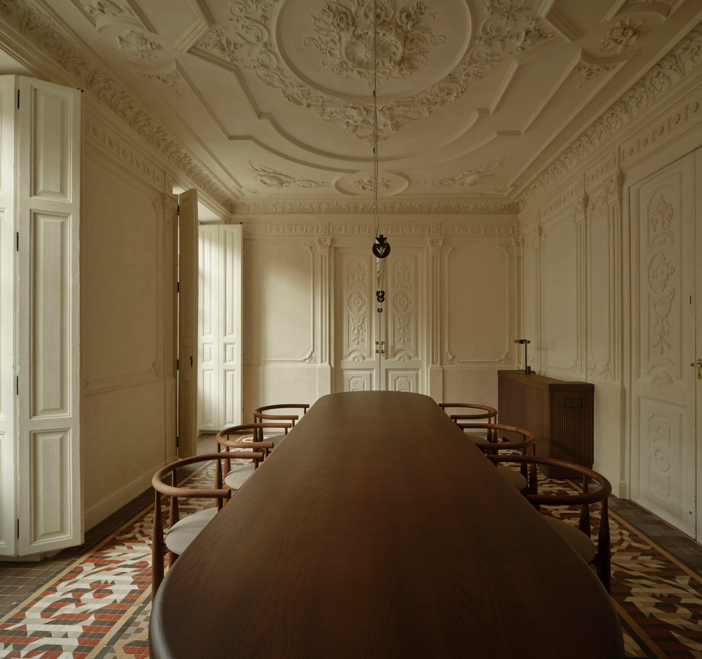Ciutat Vella Apartment — dining room and enfilade, the long table beneath restored cornices