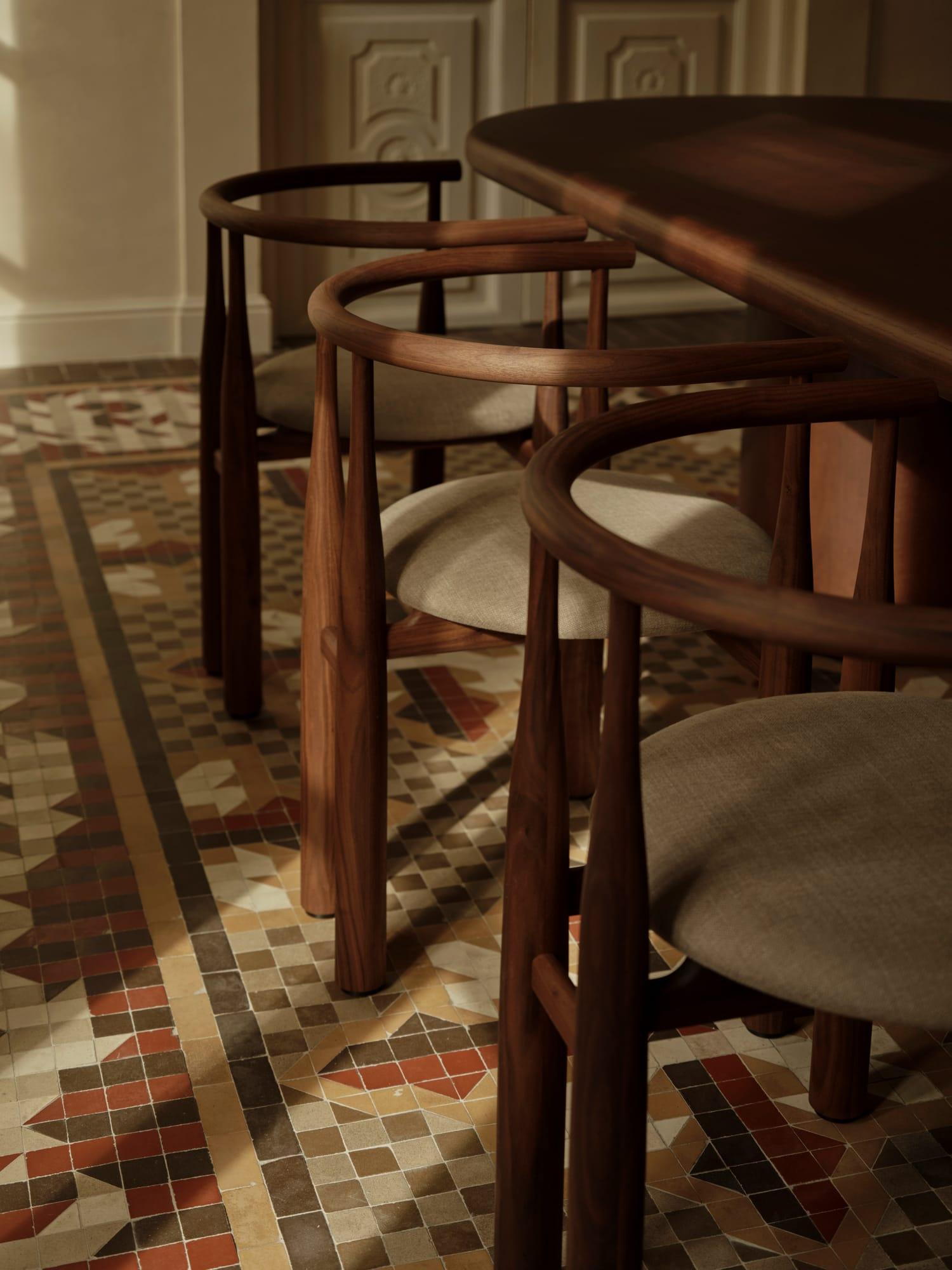 Ciutat Vella Apartment — dining chairs on the geometric Nolla mosaic