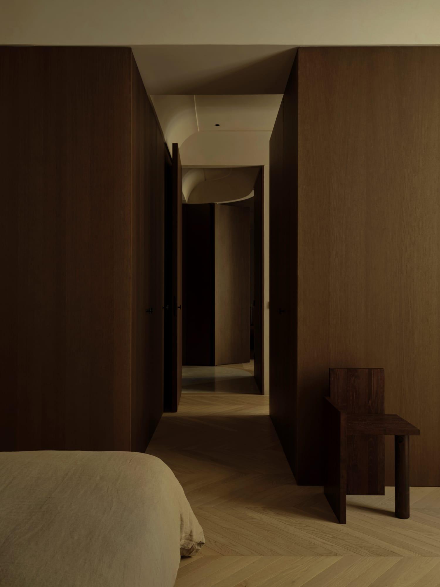 Ciutat Vella Apartment — oak-lined corridor with a bench at its end