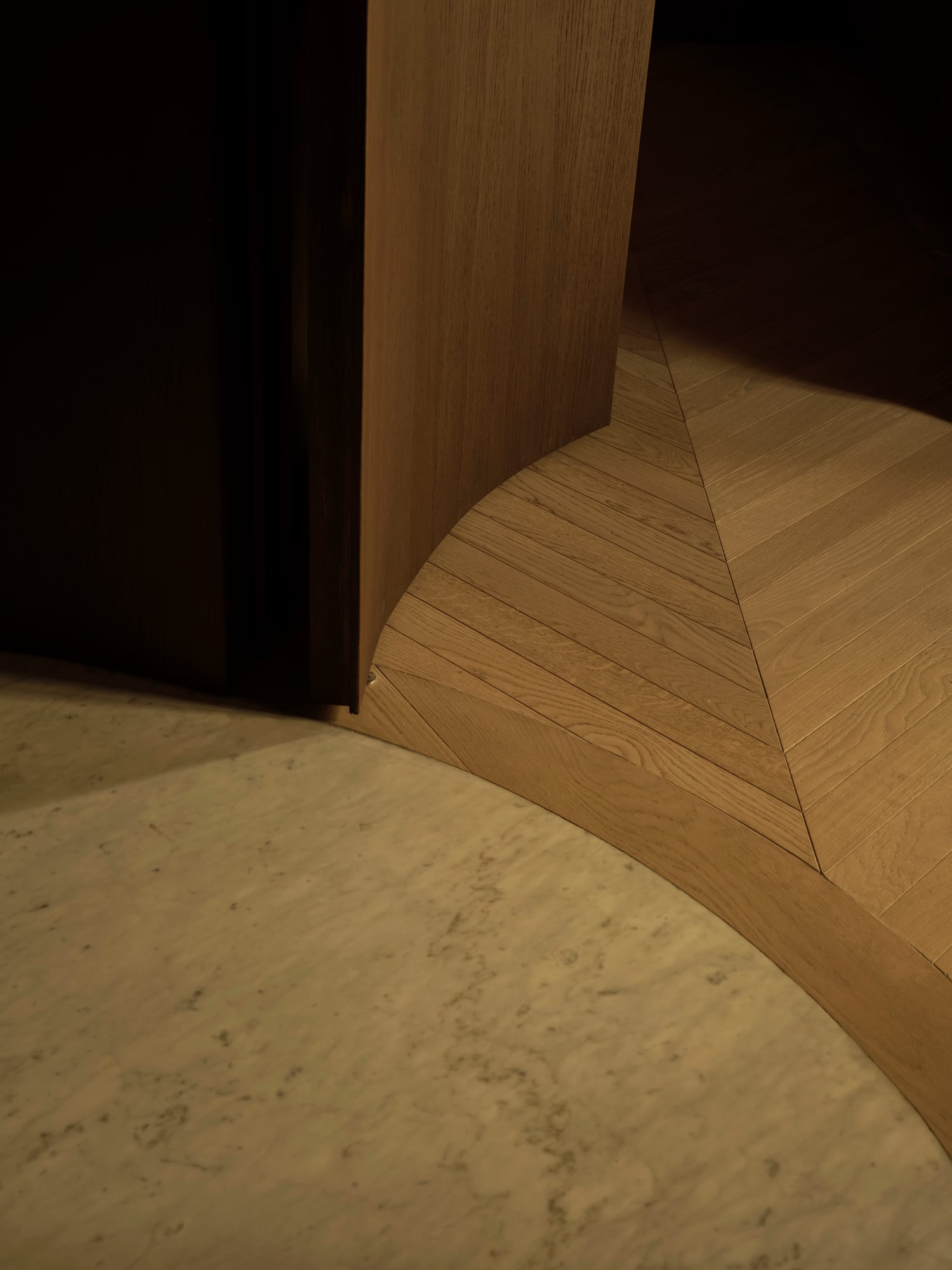 Ciutat Vella Apartment — the curved threshold where stone gives way to oak laid in chevron