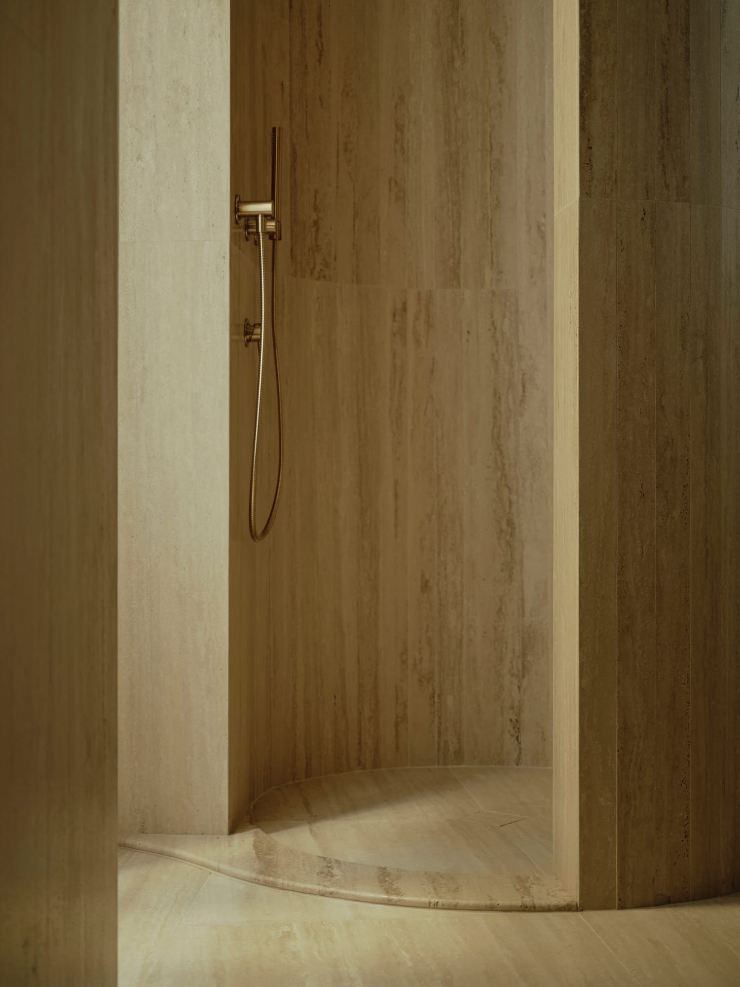 Ciutat Vella Apartment — travertine shower with brass fittings