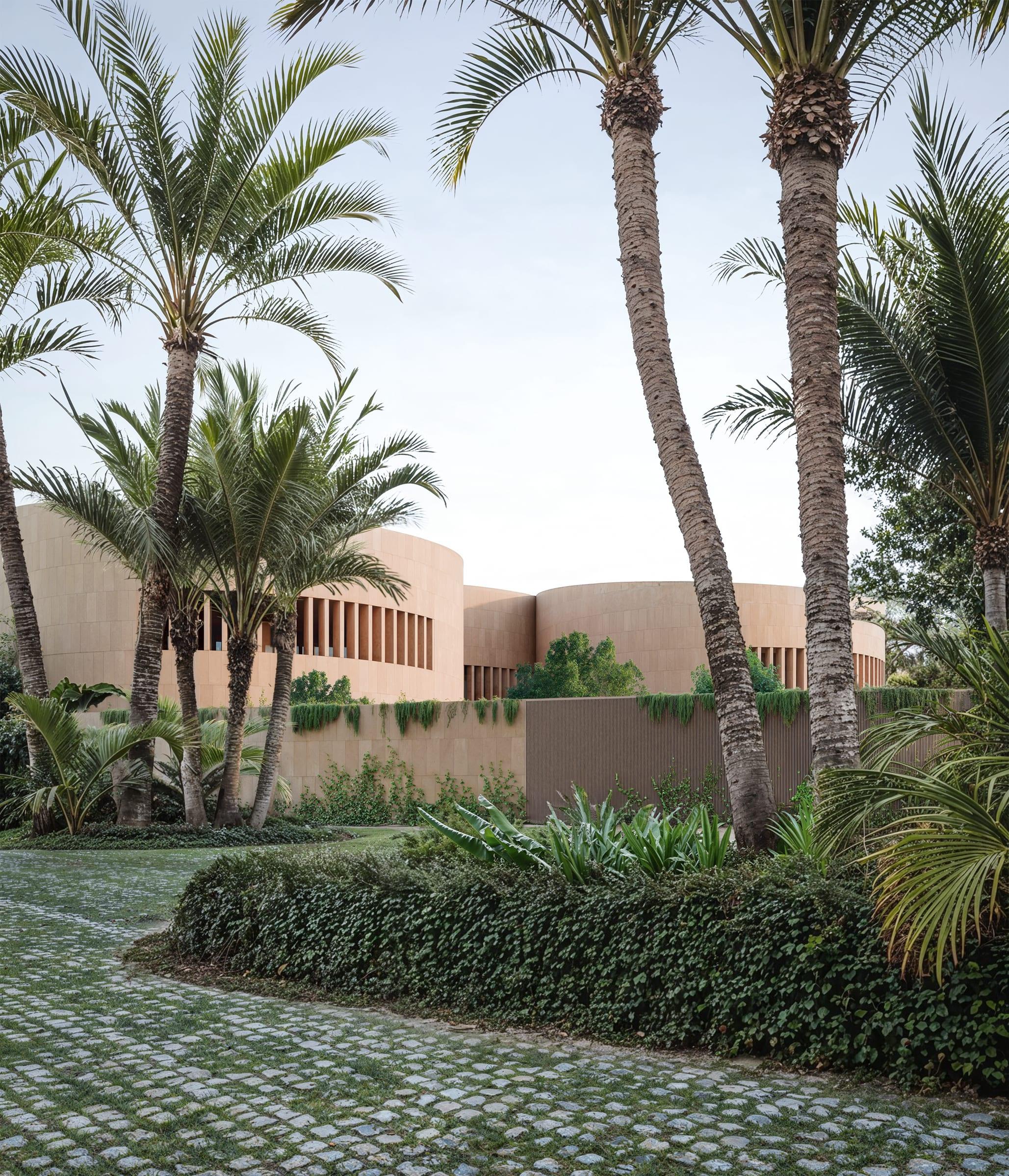 Round House — warm lime surface of the curved volumes in evening light