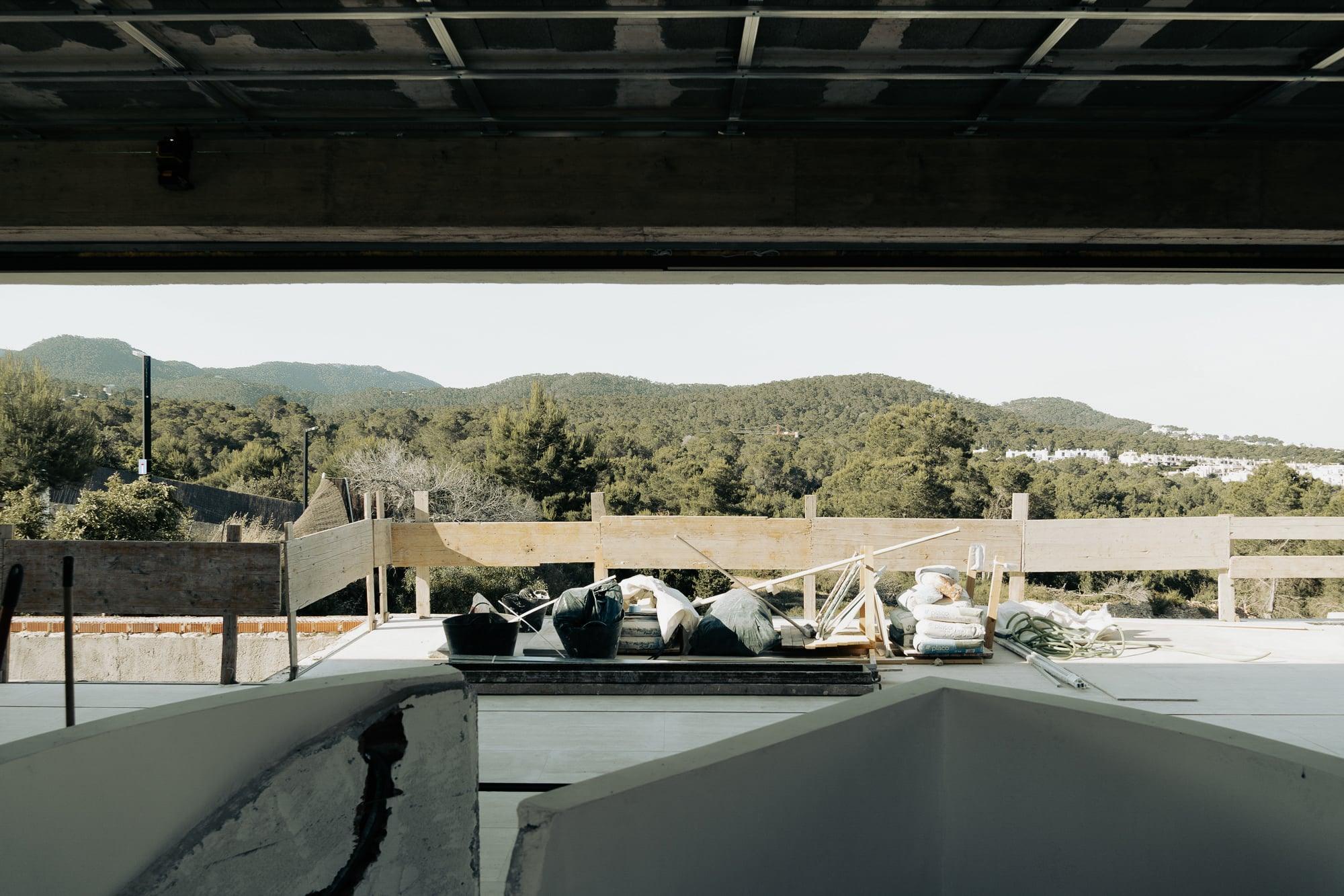 Pine landscape framed through the concrete structure under construction, Bunker House, Ibiza