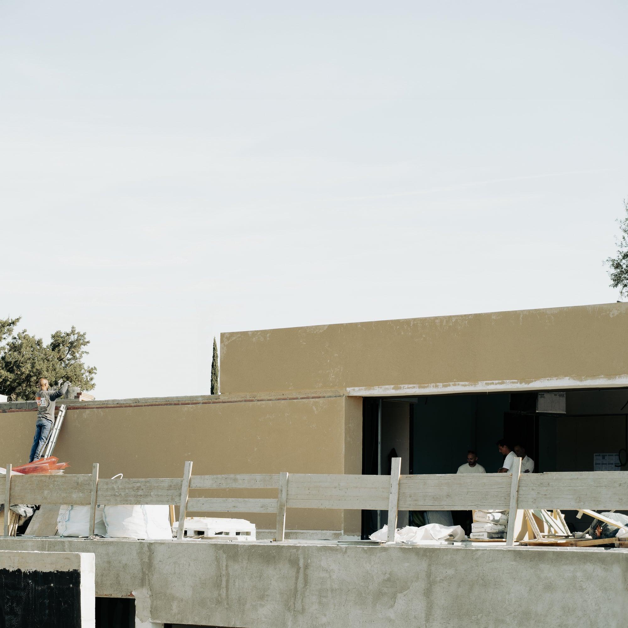 Rendering the facade on site, Bunker House under construction, Ibiza