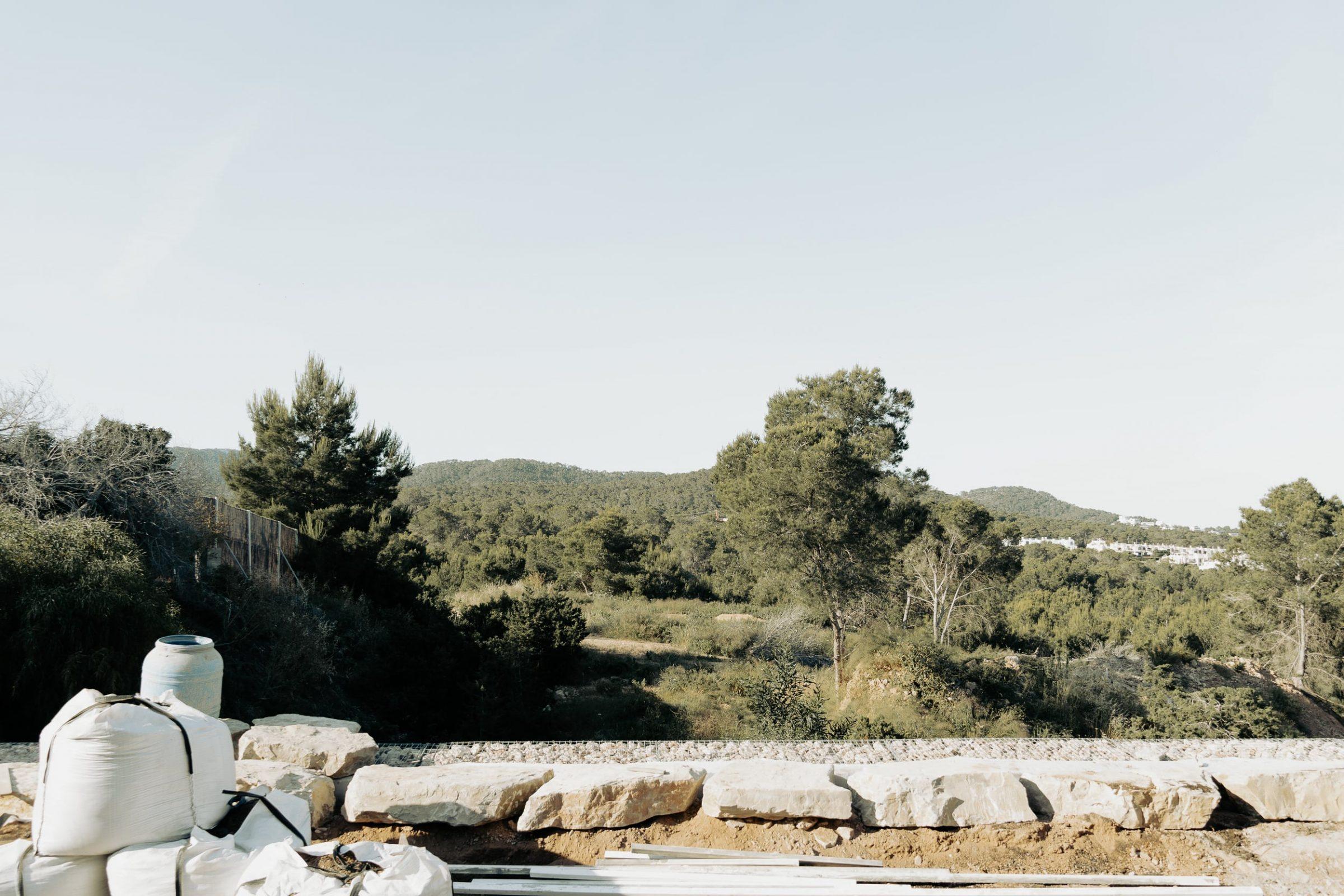 Site context above Cala Tarida, pine woodland and stone retaining wall, Bunker House, Ibiza