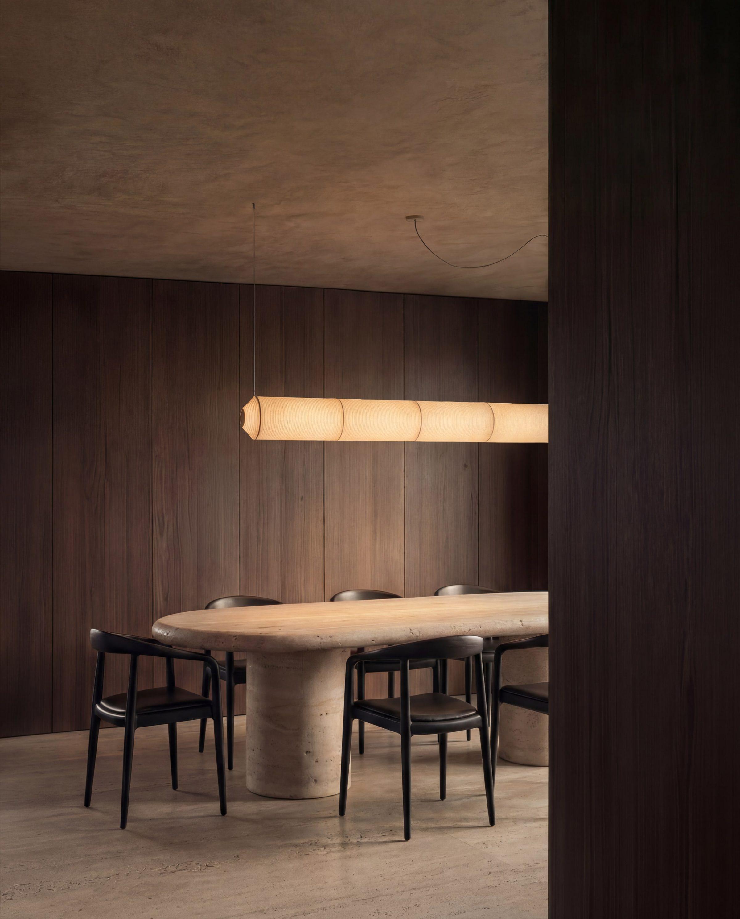 El Gouna House — dining room under a hung lamp, the darker register