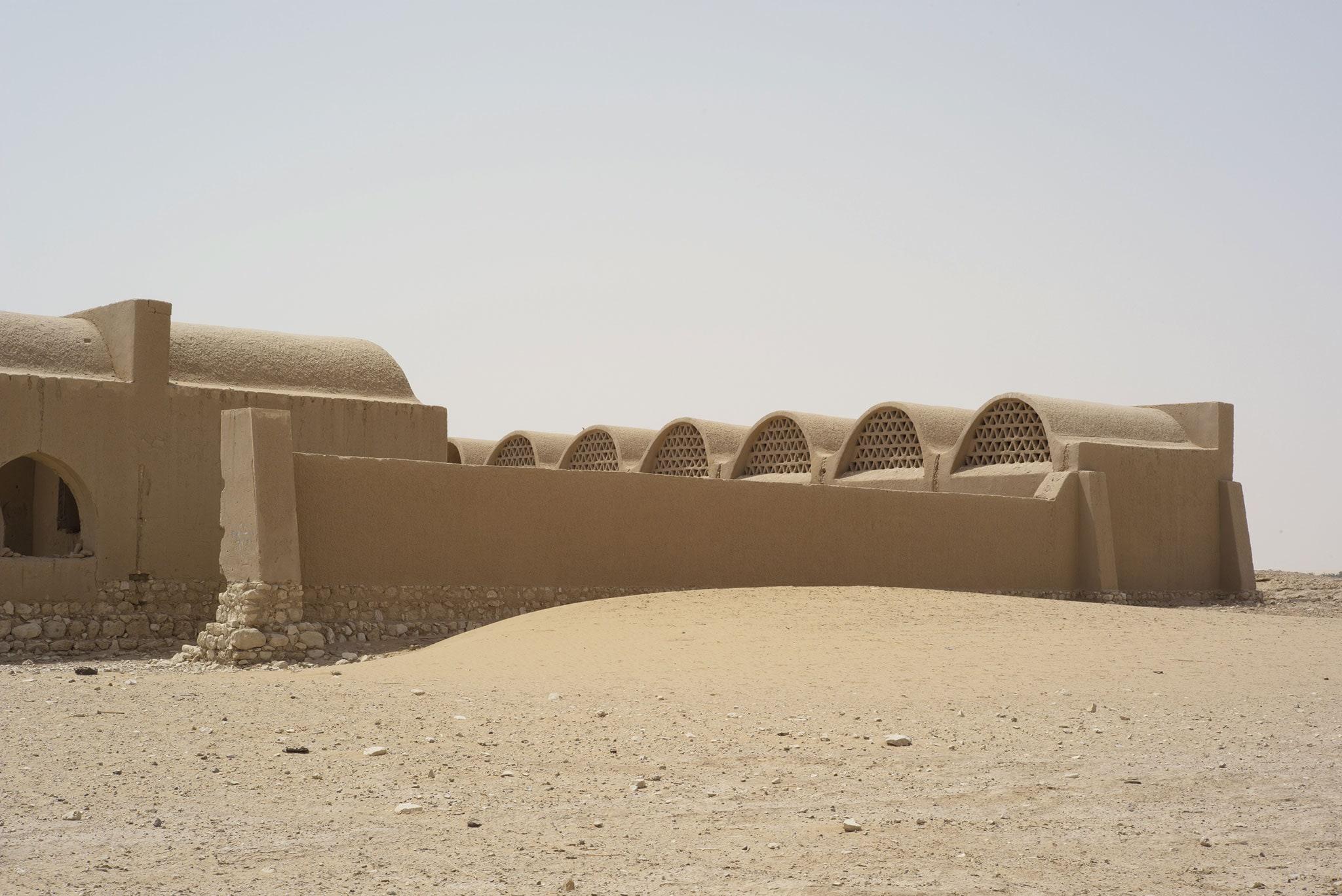 El Gouna House — reference: Hassan Fathy, New Gourna, Egypt (mass wall, vaults, courtyard)