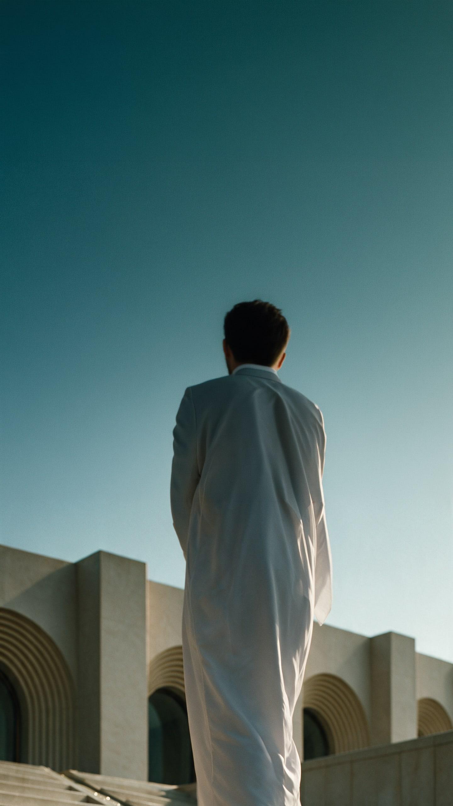 Museum of Contemporary Art, Saudi Arabia — a visitor at the top of the stair, facing the arcaded front